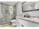 Modern bathroom featuring tiled walk-in shower with glass door and granite vanity at 2136 Briarwood Ct, Snellville, GA 30078