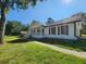 Charming white home featuring a welcoming porch, well-kept lawn, and beautiful, mature trees at 2136 Briarwood Ct, Snellville, GA 30078