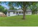 Charming, single-story home with white facade, dark shutters, and a welcoming front porch at 2136 Briarwood Ct, Snellville, GA 30078