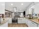 Modern kitchen with granite countertops, stainless appliances, and open view to the living area at 2136 Briarwood Ct, Snellville, GA 30078