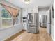 Bright kitchen featuring stainless steel appliances, white cabinets, wood floors and a window overlooking the yard at 2136 Briarwood Ct, Snellville, GA 30078