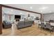 Open-concept living space with wood floors, brick fireplace, and a kitchen with an island at 2136 Briarwood Ct, Snellville, GA 30078