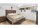 Spacious main bedroom with wood floors, decorative hats, and a large window at 2136 Briarwood Ct, Snellville, GA 30078