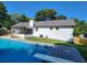 Refreshing backyard pool with diving board and screened patio, perfect for outdoor relaxation at 2136 Briarwood Ct, Snellville, GA 30078