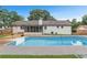 Back of home with an in-ground pool and screened in patio at 2136 Briarwood Ct, Snellville, GA 30078