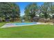 Large in-ground swimming pool in a well-maintained backyard with lush green grass and a gazebo at 2136 Briarwood Ct, Snellville, GA 30078
