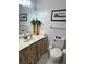 Bathroom featuring linoleum floors, a single sink with a decorative vanity, and toilet at 2194 Meadow Dr, Snellville, GA 30078