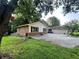 A charming exterior view of the house showcasing a well-kept lawn and mature trees at 2194 Meadow Dr, Snellville, GA 30078