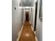 Hallway featuring wood floors, neutral walls, and doors leading to other rooms at 2194 Meadow Dr, Snellville, GA 30078