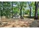 Large backyard featuring mature trees, a brick fire pit, and wooden fence, providing a private outdoor retreat at 103 Willow Wood Se Cir, Atlanta, GA 30317