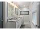 Well-lit bathroom featuring granite counters, a glass enclosed shower with white tile and decorative black tile accents at 103 Willow Wood Se Cir, Atlanta, GA 30317