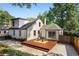 Aerial view of the property featuring a backyard deck, brick patio, well-maintained landscaping, and charming architecture at 103 Willow Wood Se Cir, Atlanta, GA 30317