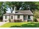 Charming brick home with a well-manicured lawn and lush greenery at 103 Willow Wood Se Cir, Atlanta, GA 30317