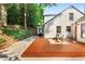 Charming backyard featuring a wooden deck, stone stairs, mature trees, and a well-maintained lawn at 103 Willow Wood Se Cir, Atlanta, GA 30317