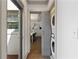Hallway featuring a laundry closet, access to outdoor patio, and view of dining room at 103 Willow Wood Se Cir, Atlanta, GA 30317