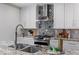 Modern kitchen featuring granite countertops, stainless steel appliances, and decorative backsplash at 103 Willow Wood Se Cir, Atlanta, GA 30317