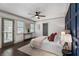 Sunlit main bedroom featuring panel accent wall, ceiling fan, and access to an outdoor patio at 103 Willow Wood Se Cir, Atlanta, GA 30317