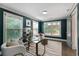 Bright office space featuring a glass table, a neutral rug, and three large windows at 103 Willow Wood Se Cir, Atlanta, GA 30317