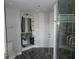 Modern bathroom with glass sink, open shelving, and walk-in shower with glass door at 115 W Peachtree Nw Pl # 702, Atlanta, GA 30313