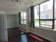 Bedroom featuring hardwood floors, large windows with city views, and closet doors at 115 W Peachtree Nw Pl # 702, Atlanta, GA 30313