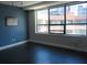Cozy bedroom with hardwood floors, large window, and blue accent wall at 115 W Peachtree Nw Pl # 702, Atlanta, GA 30313
