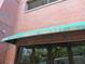 Close up shot of 115 West Peachtree Place building's awning and entrance with brick exterior at 115 W Peachtree Nw Pl # 702, Atlanta, GA 30313