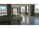 Open kitchen concept with granite countertops, white cabinets, tile flooring, and bright windows at 115 W Peachtree Nw Pl # 702, Atlanta, GA 30313