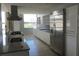 Modern kitchen featuring stainless steel appliances, white cabinets, granite countertops, and tile flooring at 115 W Peachtree Nw Pl # 702, Atlanta, GA 30313