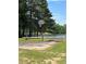Outdoor basketball court with a rustic wooden barrier next to the lake and green trees at 2510 Lakeshore Ne Dr, Conyers, GA 30012