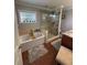 Bathroom featuring a jacuzzi style tub and tiled shower with glass door at 2510 Lakeshore Ne Dr, Conyers, GA 30012