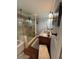Bathroom with walk-in shower, granite countertops and tub at 2510 Lakeshore Ne Dr, Conyers, GA 30012