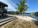 Lakeside beach featuring a swing set, picnic shelter and dock with stairs at 2510 Lakeshore Ne Dr, Conyers, GA 30012