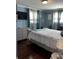 Comfortable bedroom with gray accent wall, modern dresser, TV, and a patterned bedspread at 2510 Lakeshore Ne Dr, Conyers, GA 30012
