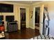 Bedroom featuring hardwood floors, crown molding, closet, and doorway to an upstairs hallway at 2510 Lakeshore Ne Dr, Conyers, GA 30012