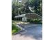Metal carport structure and an outbuilding, offering covered parking and additional storage at 2510 Lakeshore Ne Dr, Conyers, GA 30012