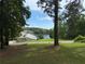 Lakeside home surrounded by lush trees and a grassy yard, providing stunning views at 2510 Lakeshore Ne Dr, Conyers, GA 30012