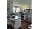 Well-lit kitchen with white cabinets, granite countertops and stainless appliances at 2510 Lakeshore Ne Dr, Conyers, GA 30012