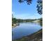 Scenic lake view with calm waters reflecting the clear blue sky and surrounding trees at 2510 Lakeshore Ne Dr, Conyers, GA 30012