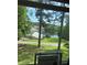 Scenic lake view with two-story home surrounded by mature trees and landscaped grounds at 2510 Lakeshore Ne Dr, Conyers, GA 30012