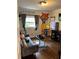 Living room featuring hardwood floors, gray couch, large window, and unique custom wall art at 2510 Lakeshore Ne Dr, Conyers, GA 30012