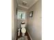 Well-lit powder room with single window and modern fixtures at 2510 Lakeshore Ne Dr, Conyers, GA 30012