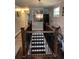 Elegant staircase featuring decorative wrought iron railings and modern chandelier lighting at 2510 Lakeshore Ne Dr, Conyers, GA 30012
