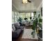 Bright sunroom with hardwood floors, office area, and ample natural light from many windows at 2510 Lakeshore Ne Dr, Conyers, GA 30012