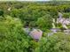 Aerial view of a home surrounded by lush trees in a quiet neighborhood, showcasing its serene and private setting at 2544 Thompson Ne Rd, Brookhaven, GA 30319