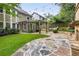 The outdoor area showcases a stone patio, lush green lawn, a covered pergola, and beautiful landscaping at 2544 Thompson Ne Rd, Brookhaven, GA 30319