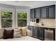 Stylish bar area featuring cabinetry, sink, and mini fridge, perfect for entertaining guests or relaxation at 2544 Thompson Ne Rd, Brookhaven, GA 30319