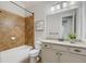 Well-lit bathroom showcases a granite countertop vanity, framed mirror, and tiled tub and shower at 2544 Thompson Ne Rd, Brookhaven, GA 30319