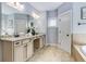 Bathroom features double granite vanity, neutral tiling, and soaking tub at 2544 Thompson Ne Rd, Brookhaven, GA 30319