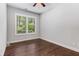 Bright bedroom features hardwood floors, large window view, and neutral wall color at 2544 Thompson Ne Rd, Brookhaven, GA 30319