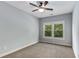 A light-filled bedroom with neutral carpet and a ceiling fan, offering a calming and comfortable space at 2544 Thompson Ne Rd, Brookhaven, GA 30319